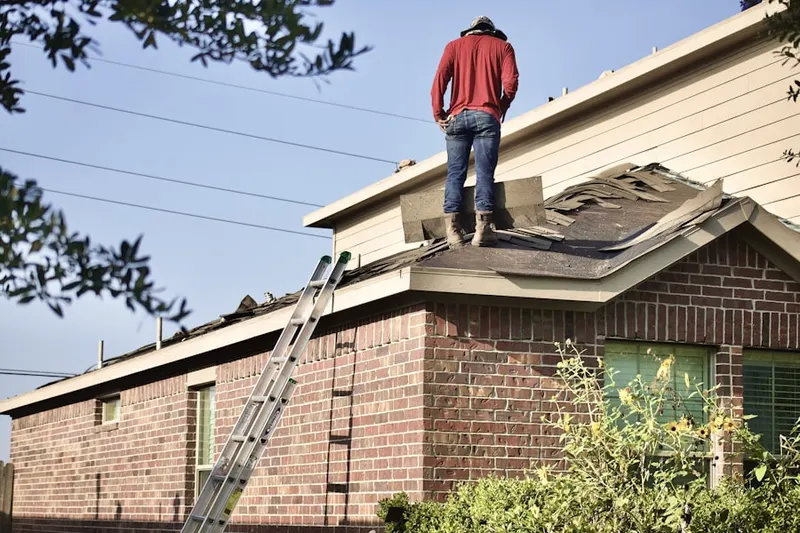 Professional roofer working on a residential roof in Pleasant Dale